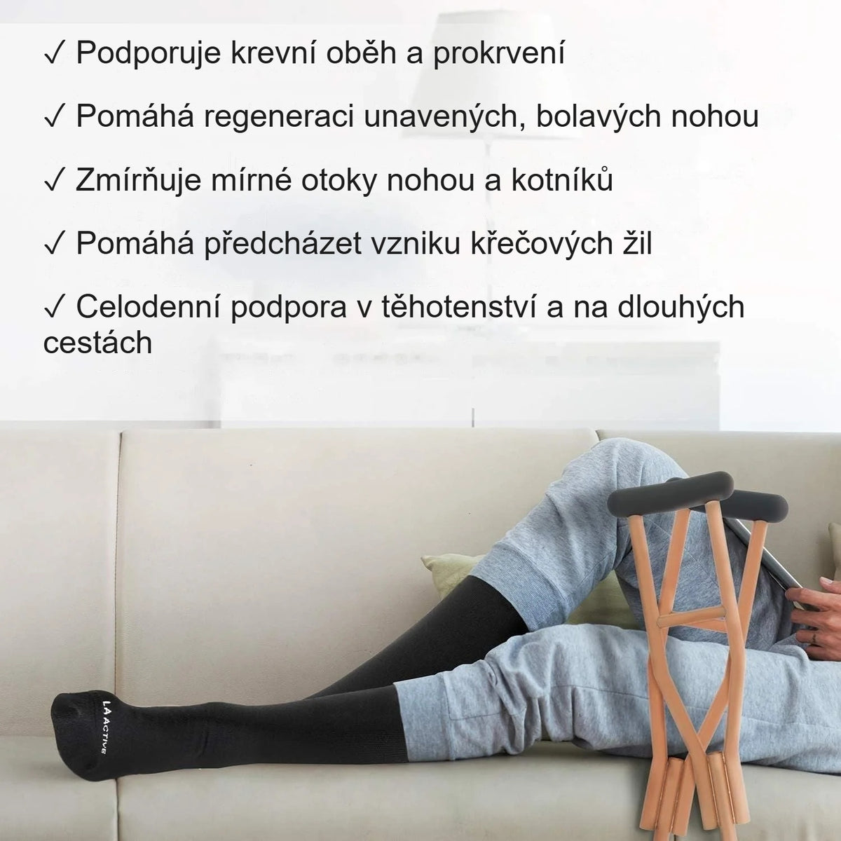 Žena se protahuje na podlaze v černých kompresních podkolenkách