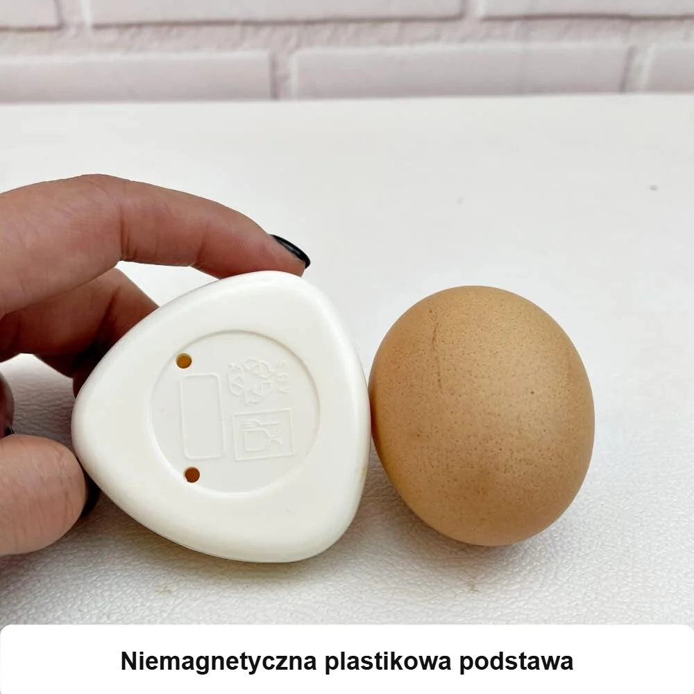 Niemagnetyczna plastikowa podstawa nakłuwacza, obok jajko